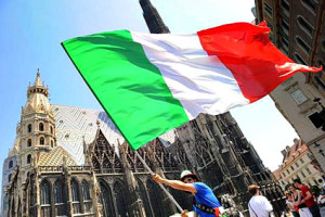 A supporter of the Italian national football team waves an Italian flag in front of St. Stephen's Cathedral in central Vienna on June 22, 2008, hours before the Euro 2008 quarter-final match Spain vs. Italy to be play at Ernst Happel stadium in Vienna. AFP PHOTO / ALBERTO PIZZOLI