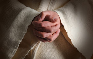 The hands of Jesus clasped in prayer